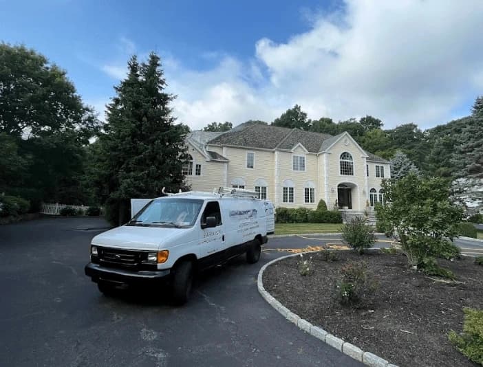 Cuyahoga Falls Power Washing technician performing thorough gutter cleaning service in Cuyahoga Falls