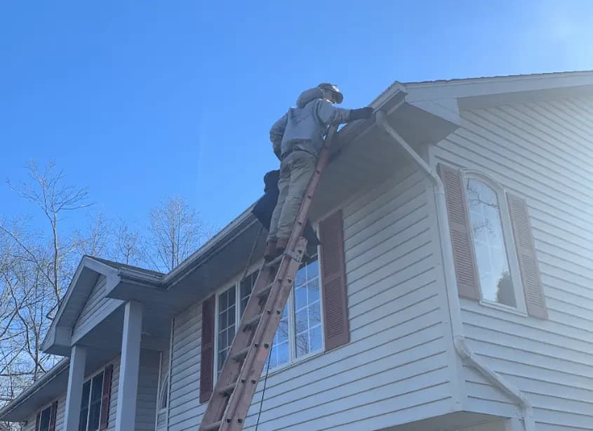 Gutter cleaning and maintenance being performed by Cuyahoga Falls Power Washing in Cuyahoga Falls